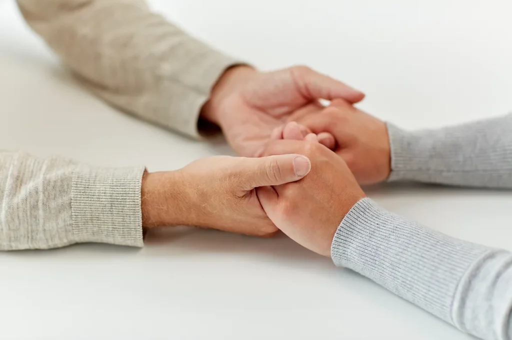 Two individuals holding hands.